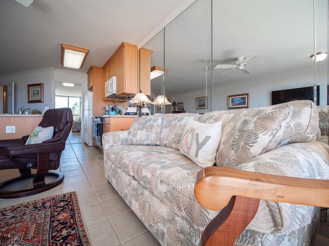 tiled living room featuring ceiling fan and crown molding