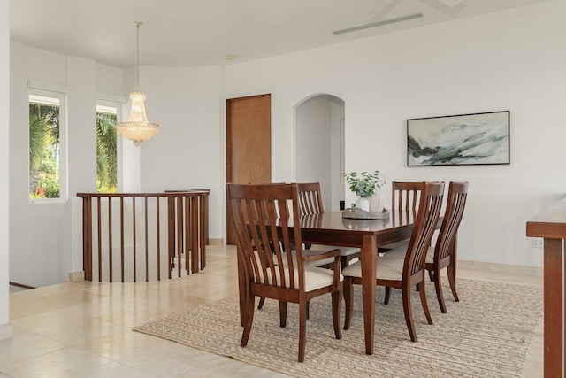 dining space featuring a notable chandelier