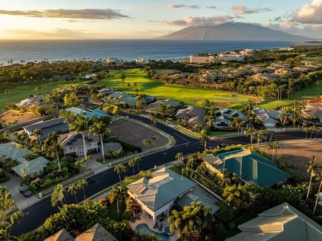 aerial view at dusk featuring a water view