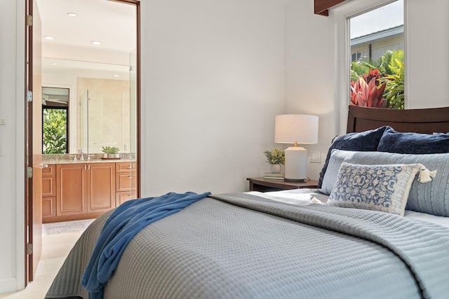 bedroom featuring connected bathroom, multiple windows, and light colored carpet