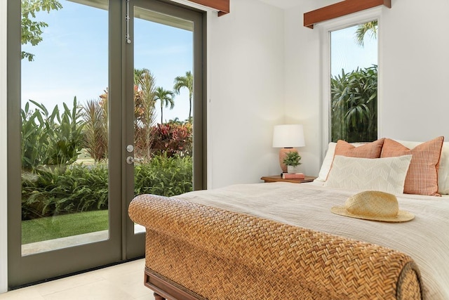 bedroom featuring light tile patterned flooring, access to exterior, and multiple windows