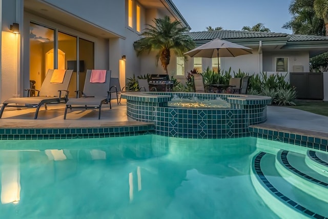 view of swimming pool with a patio area and an in ground hot tub