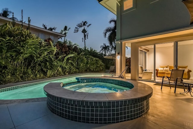 pool at dusk with an outdoor hangout area, an in ground hot tub, and a patio