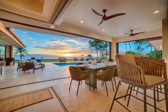 exterior space featuring a water view, ceiling fan, and a wealth of natural light