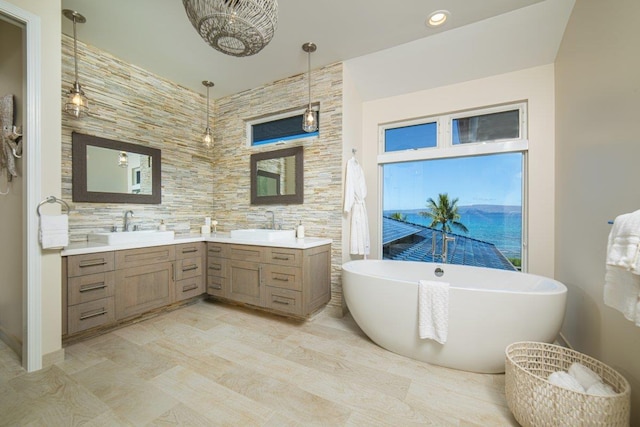 bathroom with vanity and a washtub