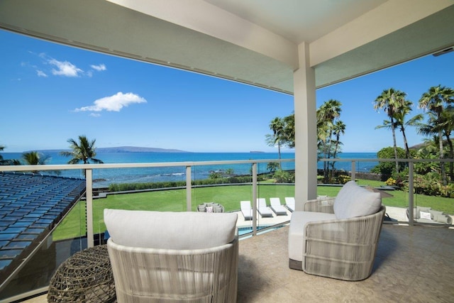 view of patio with a water view and a balcony