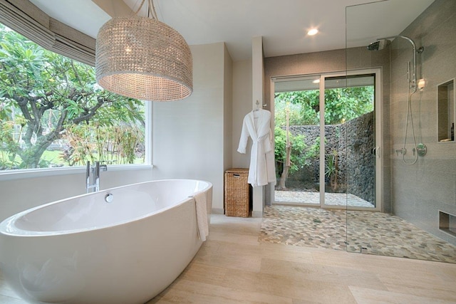 bathroom with independent shower and bath and plenty of natural light