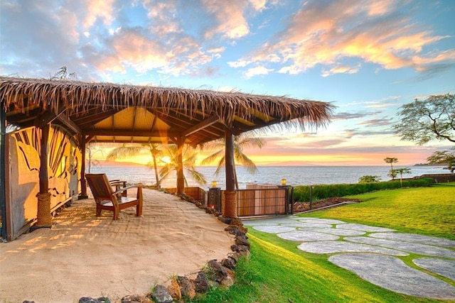 exterior space featuring a water view, a gazebo, and a yard