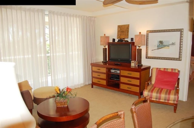 sitting room with light colored carpet and ceiling fan