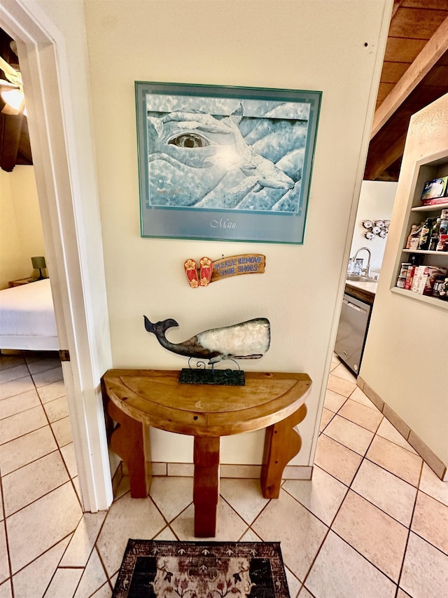 hallway with sink, built in features, and tile patterned floors