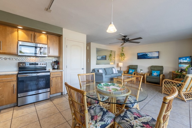 tiled dining area with ceiling fan