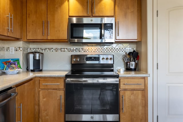 kitchen featuring decorative backsplash and appliances with stainless steel finishes