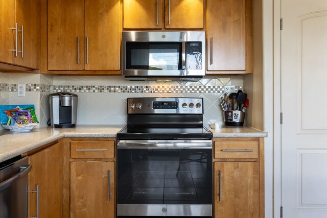 2653 S Kihei Rd Unit 114, Kihei, HI 96753 - kitchen featuring stainless steel appliances, light countertops, tasteful backsplash, and brown cabinets