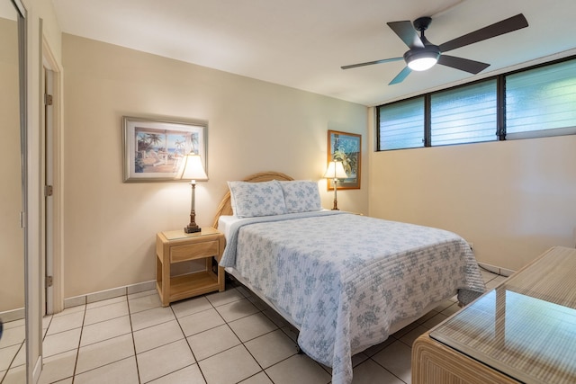 tiled bedroom featuring ceiling fan