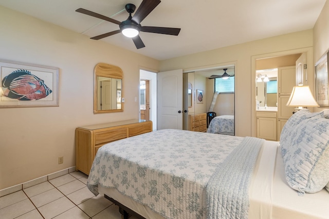 bedroom with ensuite bath, ceiling fan, and light tile patterned floors