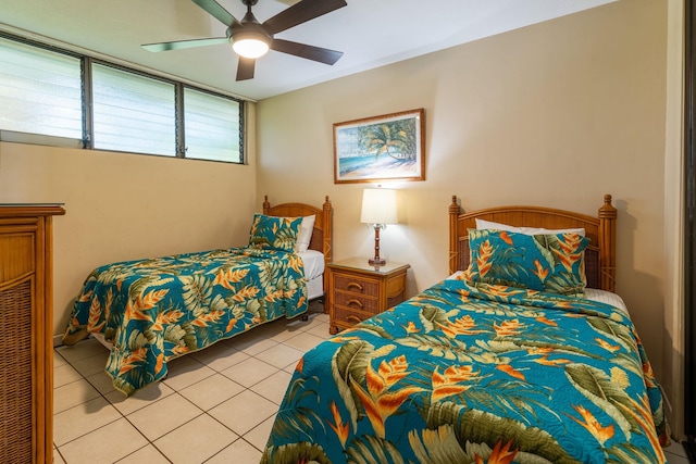 tiled bedroom featuring ceiling fan