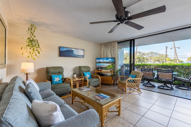 tiled living room featuring ceiling fan and a wall of windows