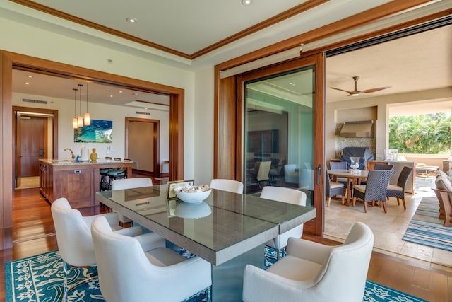 dining area featuring a ceiling fan, recessed lighting, wood finished floors, and ornamental molding