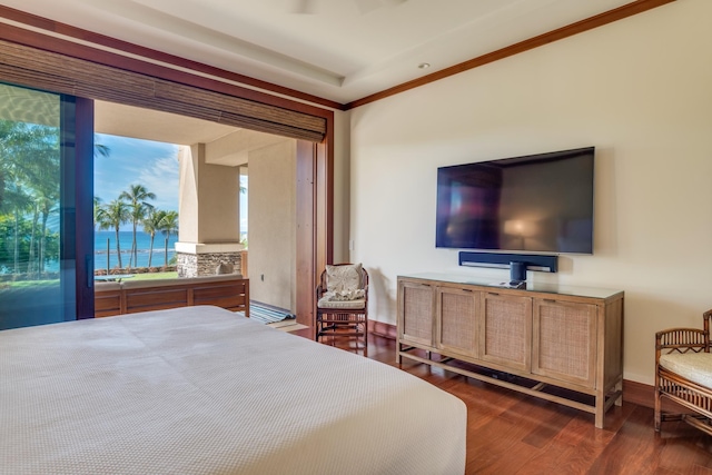 bedroom with crown molding, wood finished floors, and baseboards