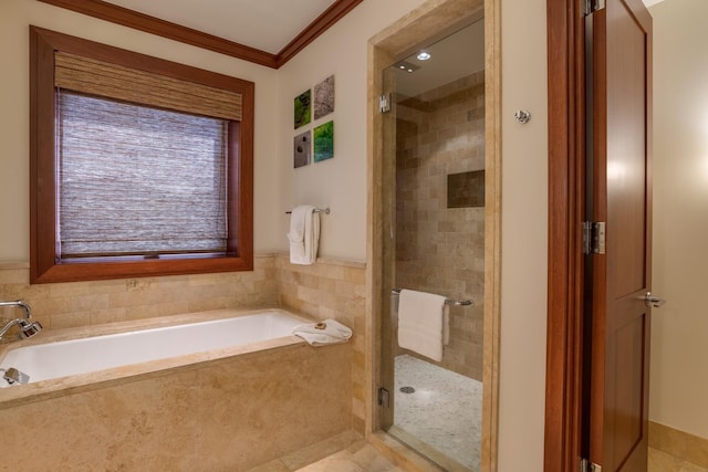 bathroom featuring a bath, a stall shower, and ornamental molding