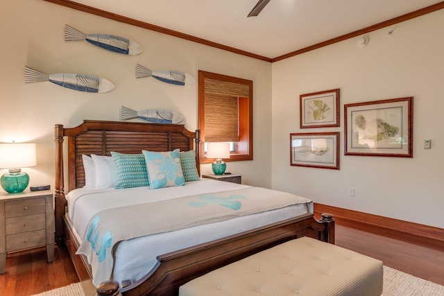 bedroom with crown molding, baseboards, and wood finished floors