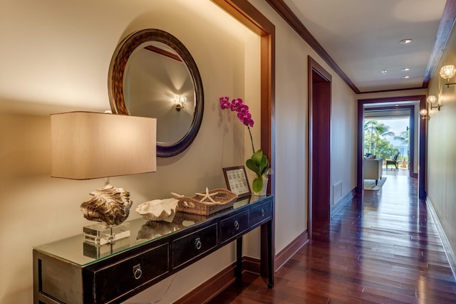 hallway featuring dark wood-style floors, recessed lighting, crown molding, and baseboards