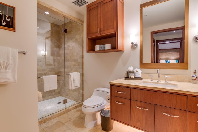 bathroom with vanity, a shower stall, toilet, and visible vents