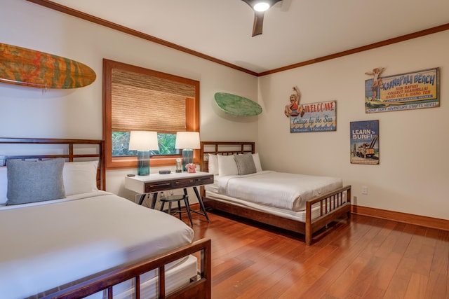 bedroom with ceiling fan, crown molding, baseboards, and wood-type flooring