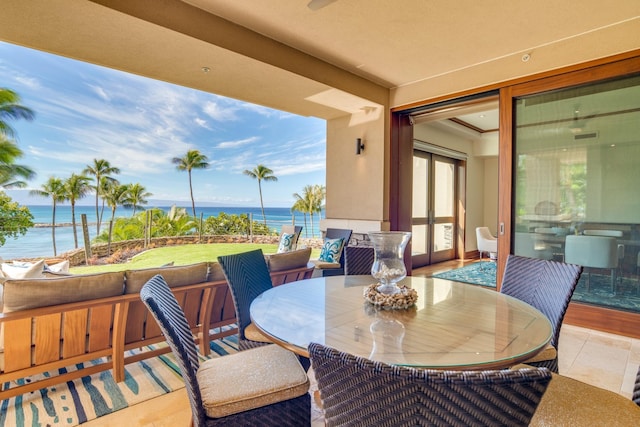 exterior space with outdoor dining area and a water view