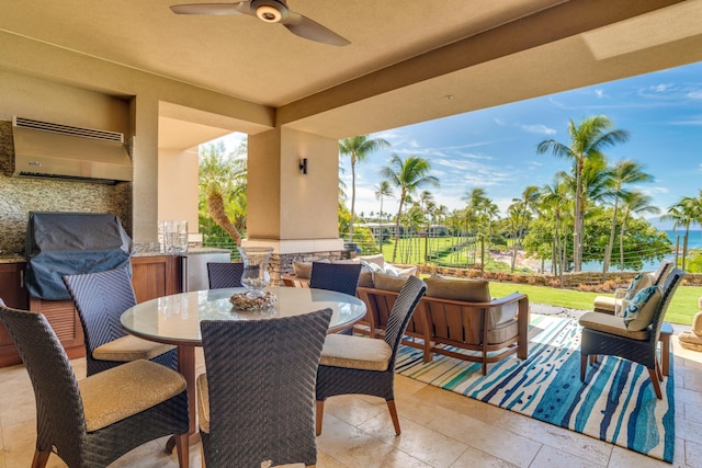 view of patio featuring ceiling fan, outdoor dining space, and fence