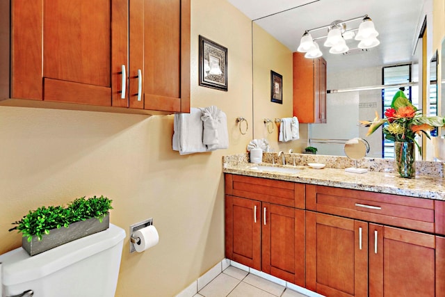 bathroom featuring tile patterned floors, vanity, and toilet