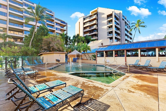 view of pool featuring pool water feature and a patio