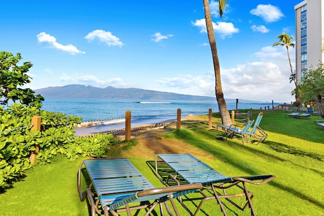 view of home's community featuring a lawn and a water and mountain view