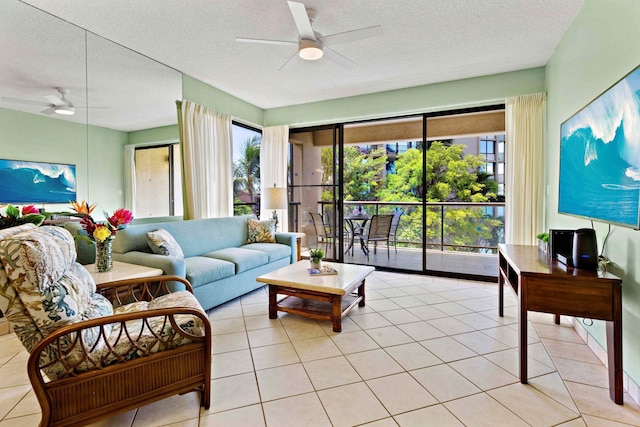 living room with a textured ceiling, ceiling fan, and light tile patterned flooring