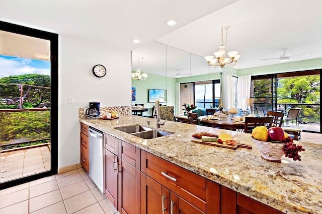 kitchen featuring dishwasher, sink, light stone counters, pendant lighting, and ceiling fan with notable chandelier