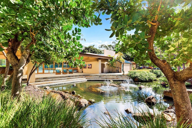 view of pool featuring a small pond