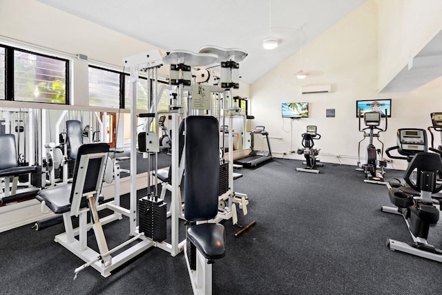 workout area with a wall unit AC and vaulted ceiling