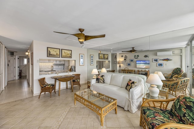 2385 S Kihei Rd Unit 306, Kihei, HI 96753 - living room featuring ceiling fan, light tile patterned floors, a wall unit AC, and baseboards