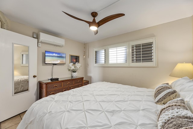2385 S Kihei Rd Unit 306, Kihei, HI 96753 - tiled bedroom featuring a wall mounted air conditioner and a ceiling fan
