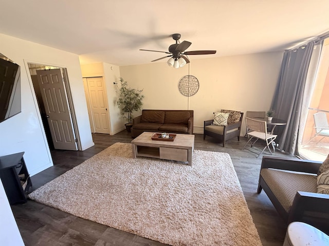 3660 Lower Honoapiilani Rd Unit 111, Lahaina, HI 96761 - living area featuring a ceiling fan, dark wood-style floors, and baseboards