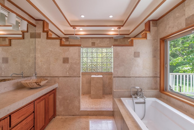 bathroom featuring a bath, tile walls, a walk in shower, vanity, and a tray ceiling