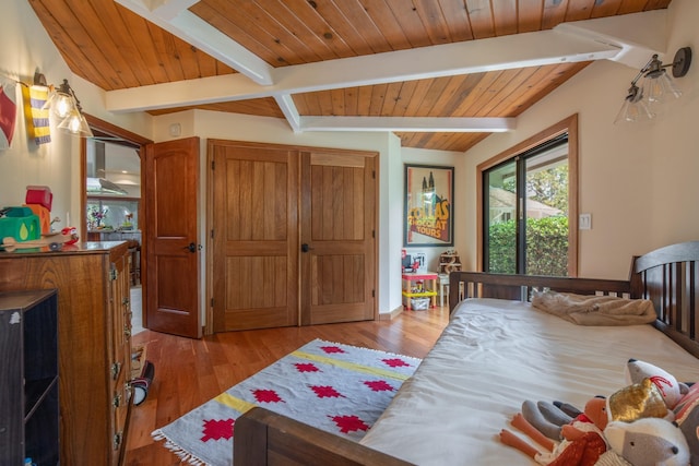 bedroom with baseboards, light wood-style flooring, beam ceiling, and wood ceiling