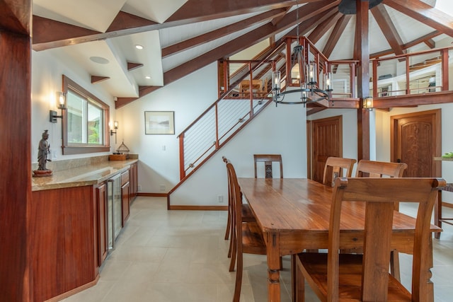 dining area featuring baseboards, lofted ceiling with beams, stairs, and a chandelier