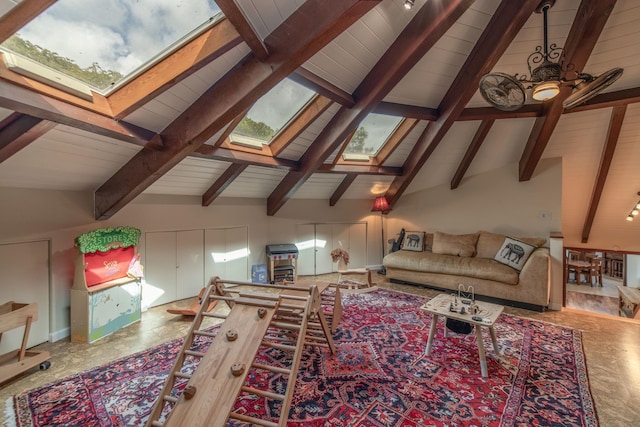 living area with beamed ceiling, a skylight, and wooden ceiling