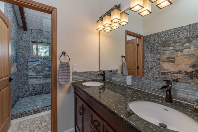 full bath with a sink, backsplash, walk in shower, and double vanity