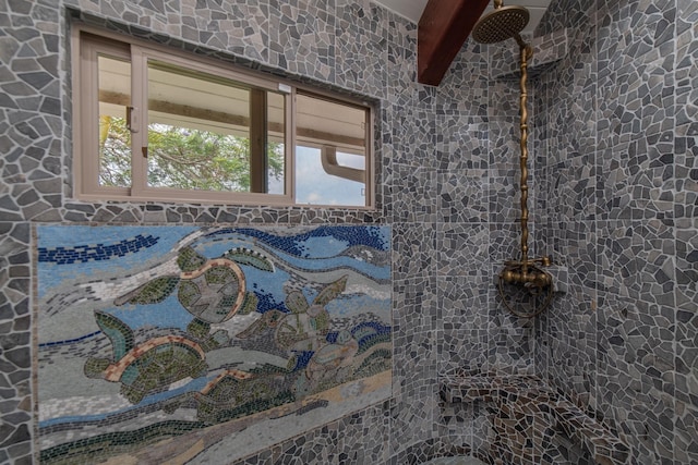 full bathroom featuring beamed ceiling and a tile shower