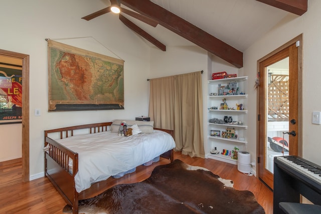 bedroom featuring lofted ceiling with beams and wood finished floors