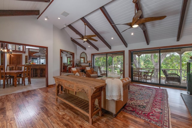 living area featuring ceiling fan, visible vents, wood finished floors, high vaulted ceiling, and beamed ceiling