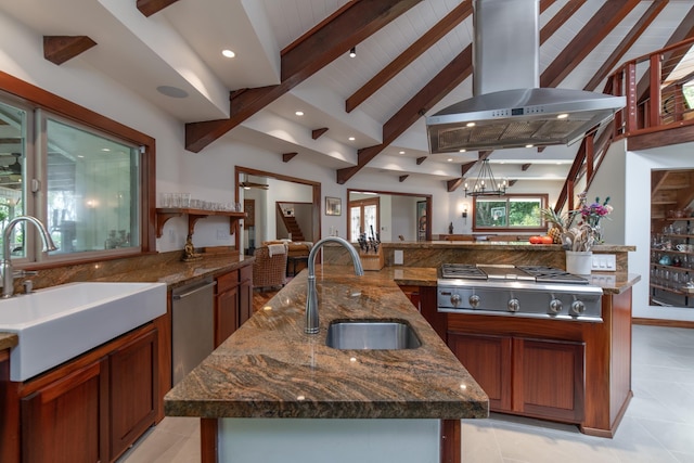 kitchen with stainless steel gas cooktop, vaulted ceiling with beams, extractor fan, and a sink