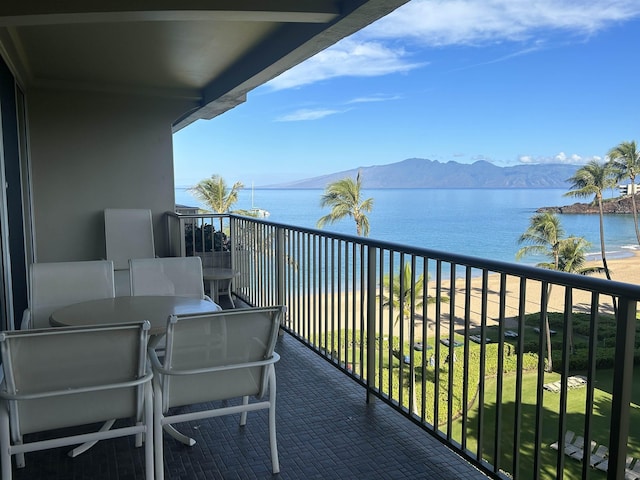 balcony featuring a water and mountain view